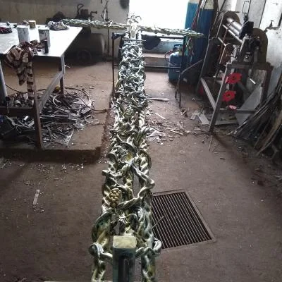 Monumentalny krzyż przydrożny wykonany ze stali z motywem Drzewa Życia, winorośli i symboliką Trójcy Świętej.